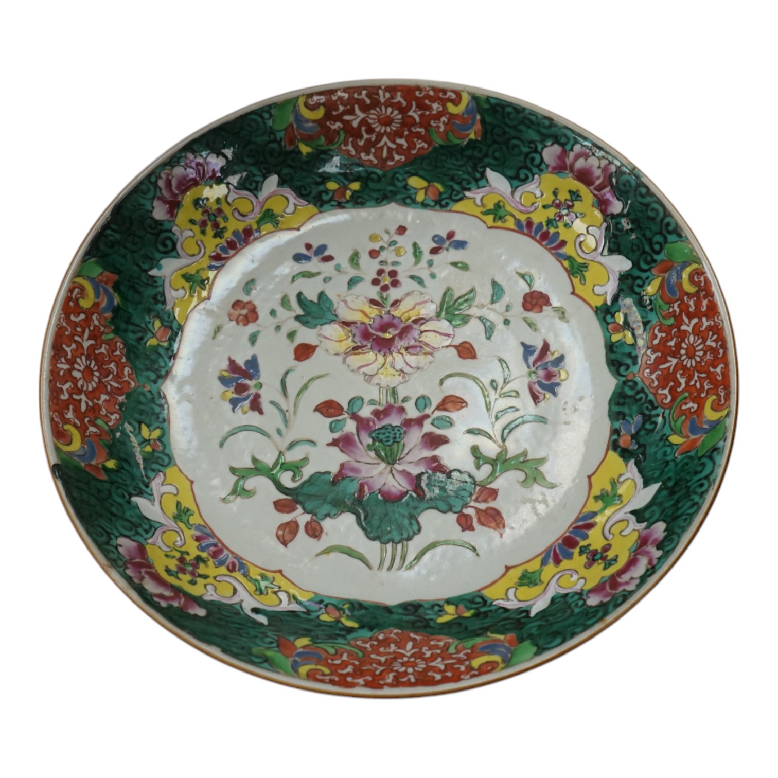 A Chinese straits famille rose dish, 19th century, 33cm diameter. Condition - crack to base